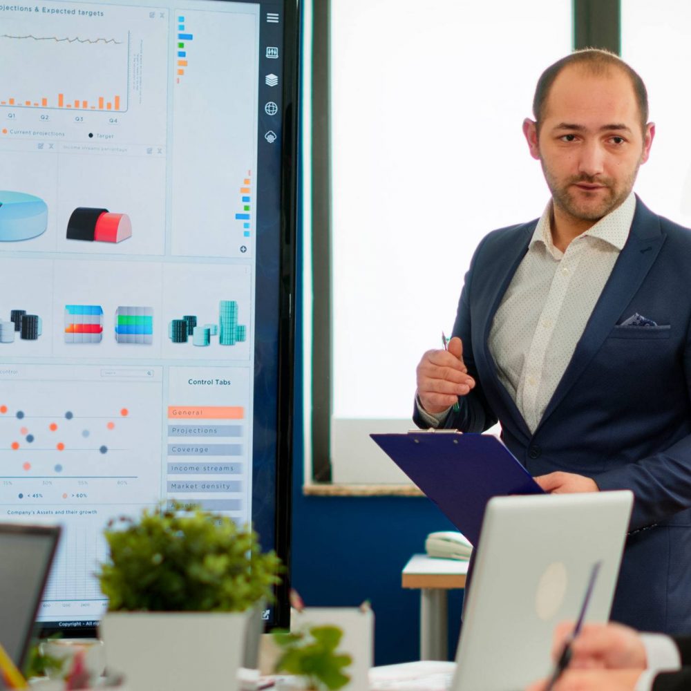executive-manager-presenting-sales-reports executive manager presenting sales reports HBABCN scaled